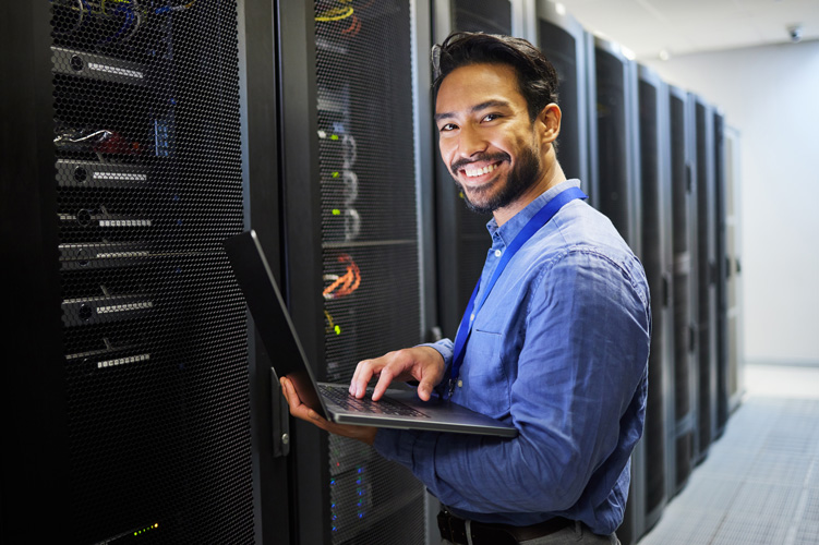 Man with laptop in data center